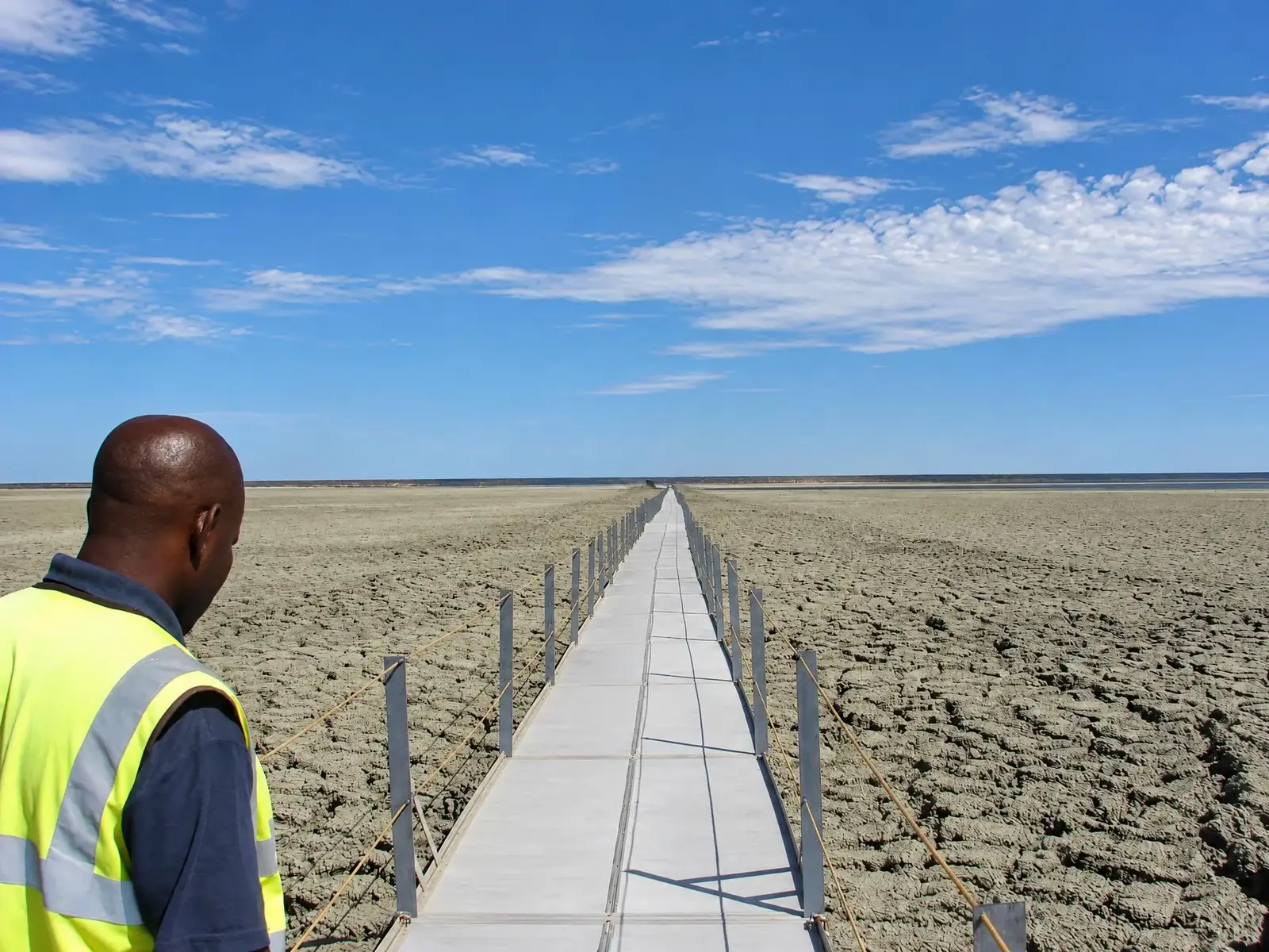 Long Xrosswater walkway across a dry diamond tailings dam in Botswana